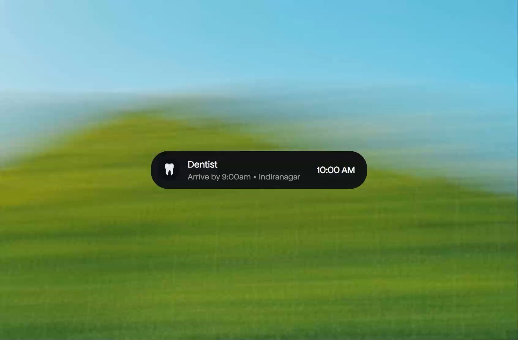 GYST reminder card reading Dentist, arrive by 9:00am, Indiranagar, 10:00 AM, over a blurred green hill and blue sky