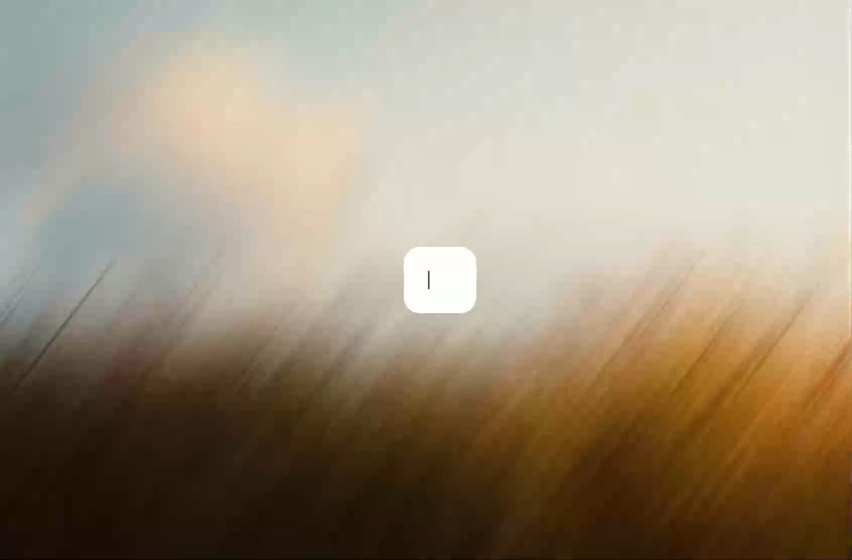 Motion-blurred landscape in amber and pale blue, with a text cursor blinking in a white input box at the centre